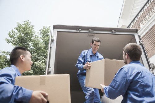 Professional removals team working in a Shepherds Bush apartment building